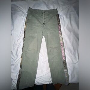 Green Anthropology pants. Patchwork down the sides of the legs. Size 27